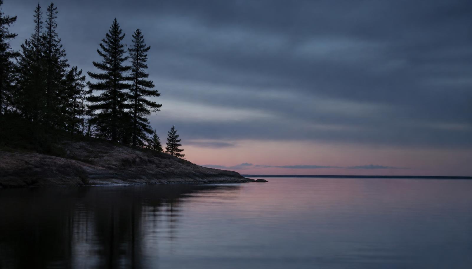 Quiet Michigan lakeshore with pines at dusk